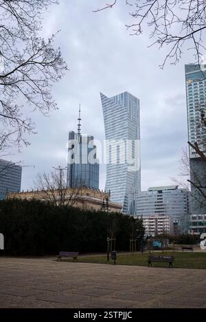 Warschau, Polen. 26. Januar 2025 - Moderne Wolkenkratzer mit einem ruhigen Park im Vordergrund an einem Wintertag. Stockfoto