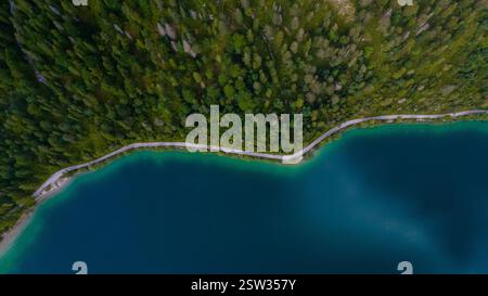 Ein ruhiger Blick fängt die Schönheit von Plansee ein, wo das türkisfarbene Wasser auf üppige grüne Hügel trifft Stockfoto