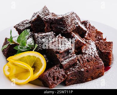 Schokoladen-Brownie-Stücke auf weißem Teller Stockfoto