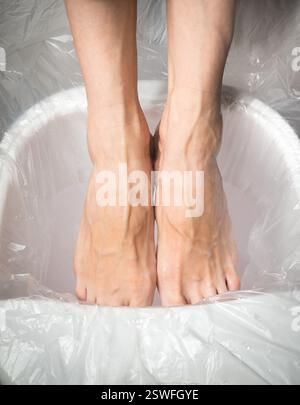 Müde Füße, Frauenfüße in einem entspannenden Bad. Stockfoto