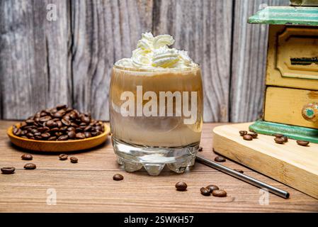 Ein Glas kalten Kaffee mit Sahne und Kaffeebohnen. Selektiver Fokus. Stockfoto