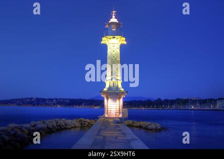 Nachtansicht auf den Leuchtturm Paquis in Genf, auf dem gleichnamigen See, Schweiz. Das Hotel liegt an der Spitze eines Stegs, der mit dem beliebten Pa aufgereiht ist Stockfoto