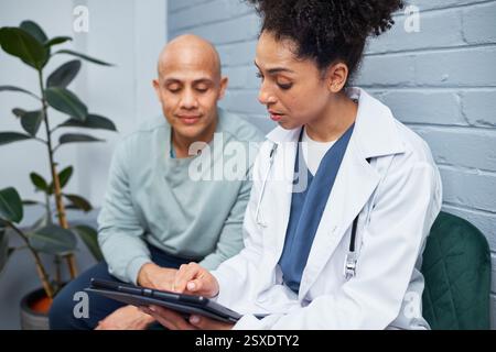 Medizinischer Berater Patient mit Tablet in der Praxis Stockfoto