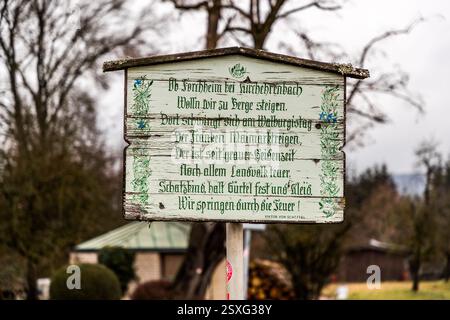 Ein Schild in Deutschland, nahe Forchheim, beschreibt eine Tradition des Wanderns und ein Festival in der Walpurgisnacht. Das Gedicht von Viktor von Scheffel beschreibt den Brauch des Gehen, Tragen bestimmter Kleidung und Springen durch Feuer. Ehrenbürgstraße, Forchheim, Bayern, Deutschland Stockfoto