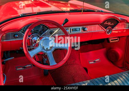 San Bruno, USA – 7. Oktober 2022: Innenraum eines roten 1956er Chevrolet Bel Air Cabriolets auf einer Autoshow mit Chromlenkrad und Vintage-Armaturenbrett Stockfoto