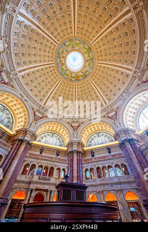 WASHINGTON DC – der Hauptlesungsraum der Library of Congress Thomas Jefferson Building verfügt über eine prächtige Kuppeldecke mit Edwin Blashfields allegorischen Gemälden, die Länder darstellen, die zur westlichen Zivilisation beigetragen haben. Acht riesige Marmorsäulen tragen 10 Fuß hohe Gipsfiguren, die Religion, Handel, Geschichte, Kunst, Philosophie, Poesie, Recht und Wissenschaft. Der zentrale Leseraum darunter enthält in konzentrischen Kreisen angeordnete Forscherpulte unter dem 1897 fertiggestellten architektonischen Meisterwerk. Stockfoto