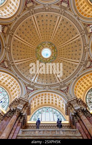WASHINGTON DC – der Hauptlesungsraum der Library of Congress Thomas Jefferson Building verfügt über eine prächtige Kuppeldecke mit Edwin Blashfields allegorischen Gemälden, die Länder darstellen, die zur westlichen Zivilisation beigetragen haben. Acht riesige Marmorsäulen tragen 10 Fuß hohe Gipsfiguren, die Religion, Handel, Geschichte, Kunst, Philosophie, Poesie, Recht und Wissenschaft. Der zentrale Leseraum darunter enthält in konzentrischen Kreisen angeordnete Forscherpulte unter dem 1897 fertiggestellten architektonischen Meisterwerk. Stockfoto