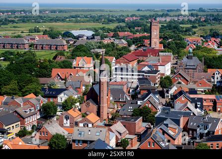 Borkum, Deutschland. Juni 2024. Zahlreiche Häuser sowie die katholische Kirche Maria Meeresstern und der Alte Leuchtturm (dahinter) befinden sich im Ortskern der Nordseeinsel Borkum, fotografiert vom Neuen Leuchtturm. Quelle: Hauke-Christian Dittrich/dpa/Alamy Live News Stockfoto
