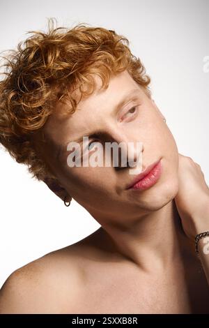 Junger Mann mit auffälligen Merkmalen, der seinen Sinn für Mode und seinen fesselnden Charme zum Ausdruck bringt. Stockfoto