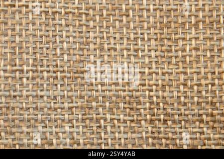 Hellbeige oder gelbe natürliche Textur aus rauem Leinenstoff-Hintergrund. Stoff Leinwand Textur Nahaufnahme Stockfoto