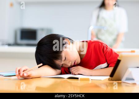 Ein Junge, der auf Einem Tisch schläft Stockfoto