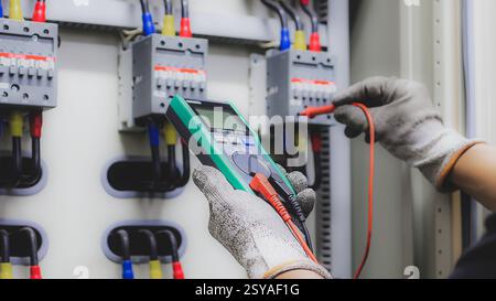 Elektroingenieur überprüft die Funktion des elektrischen Schaltschranks. Stockfoto