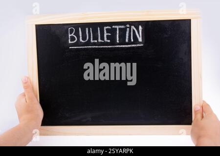 Hand holding the board  with the title of bulletin Stockfoto