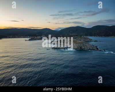 Ein malerischer Blick auf Kalamitsi Dorf und Strand in Griechenland bei Sonnenuntergang. Die zerklüftete Küste, das ruhige Meer und die sanften Hügel schaffen eine friedliche und malerische Atmosphäre Stockfoto