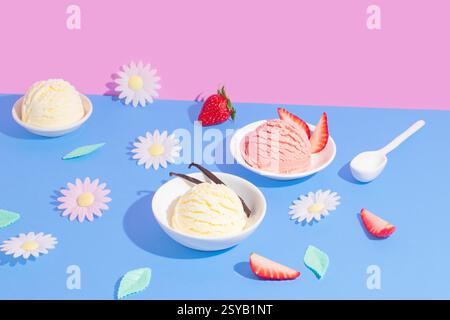 Lebendiger geteilter Hintergrund in Rosa und Blau mit verschiedenen Eissorten. Die Szene umfasst dekorative Elemente wie Blumen und Fruchtscheiben Stockfoto