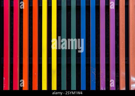 Ein farbenfroher Regenbogen wird auf schwarzem Hintergrund angezeigt. Der Regenbogen besteht aus vielen verschiedenen farbigen Streifen, von denen jeder eine andere Farbe des rai hat Stockfoto