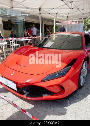 corfu, corfu, Greece. August 01, 2021: A red Ferrari 296 GTB parked near an outdoor cafe. Stockfoto