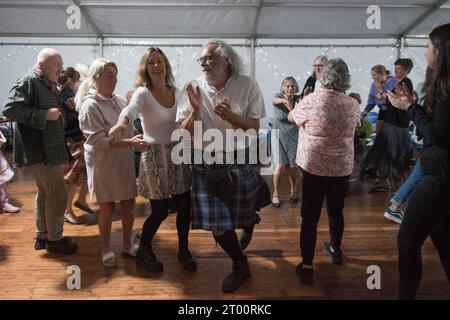 Schottische Ceilidh tanzen zu traditioneller Volksmusik. Cockenzie und Port Seton freundliche Gesellschaft der Fischer. Die Box Meeting Ceilidh in einem Festzelt am Hafen, speziell für die Veranstaltung. September 2023 Cockenzie und Port Seton, East Lothian, Schottland. HOMER SYKES AUS DEN 2020ER JAHREN Stockfoto