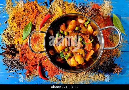 indisches Hühnercurry in Metallschüssel auf Puderhintergrund Stockfoto