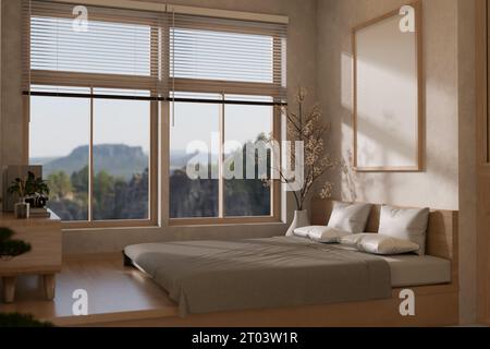 Inneneinrichtung im minimalistischen japanischen Schlafzimmerstil mit gemütlichem Bett am Fenster mit wunderschönem Blick auf die Berge, einem Rahmenmodell an der Wand, Holz Stockfoto