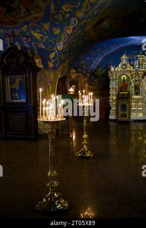 Kerzen an einem alten Stand in der mittelalterlichen Himmelfahrtskirche des Klosters Himmelfahrt der Höhlen in Nischni Nowgorod Stockfoto