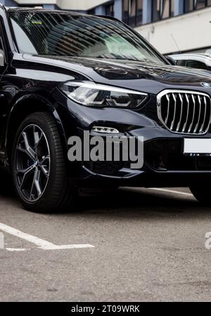 Minsk, Weißrussland, Oktober 2023 - BMW Scheinwerfer und Logo auf schwarzem Auto Stockfoto