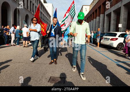 Triest, Italien - 03. September 2022: Demonstranten mit Fahnen der Vereinigten italienischen Gewerkschaften während der Demonstration gegen die Entlassungen von Arbeitern aus der Stockfoto