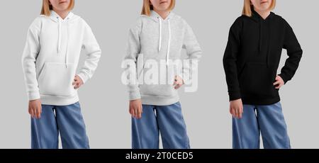 Vorlage aus weiß, Heidekraut, schwarzem Hoodie mit Tasche auf posierendem Mädchen, Kinderhemd Set, Vorderansicht, isoliert auf Hintergrund. Street Wear Mockup für Desig Stockfoto