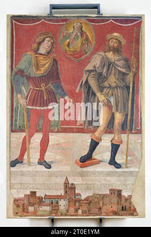 Deruta (Umbrien - PG), Städtische Kunstgalerie. Perugino, ewiger Vater mit den Heiligen Rocco und Romano (zu Füßen der Heiligen der Blick auf die Stadt Deruta), freistehendes Fresko, datiert auf 1477-78 Stockfoto