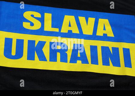 Schriftzug SLAVA UKRAINI Ruhm der Ukraine - Botschaft auf einem T-Shirt - Krieg in der Ukraine - Berlin Deutschland, DEU, DE, 30.07.2023 - Berlin-Mitte: Politischer Protest im öffentlichen Raum gegen die Kriegshandlungen in der Ukraine, ausgelöst durch den Präsidenten der Russischen Föderation Wladimir Wladimirowitsch Putin. *** Schreiben SLAVA UKRAINI Glory of Ukraine Botschaft über einen T-Shirt-Krieg in der Ukraine Berlin Deutschland, DEU, DE, 30 07 2023 Berlin Mitte politischer Protest im öffentlichen Raum gegen die Kriegshandlungen in der Ukraine, ausgelöst durch den Präsidenten der Russischen Föderation Wladimir Wladimirovi Stockfoto