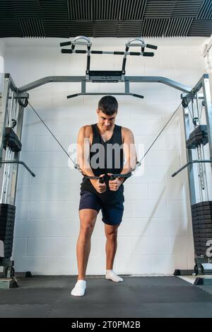 Junge, der Gewichte auf einer Übungsbank ausübt und große Kraft ausübt. Stockfoto