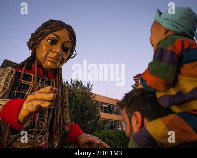 Atlanta, Georgia, USA. Oktober 2023. Die kleine Amal, eine riesige Marionette eines 10-jährigen syrischen Flüchtlingsmädchens, wendet sich an ein kleines Kind. Während Amal Gemeinden in den Vereinigten Staaten besucht, demonstriert sie die Widerstandsfähigkeit von Flüchtlingen und die Macht der Künste, verschiedene Menschen zusammenzubringen. (Credit Image: © Sue Dorfman/ZUMA Press Wire) NUR REDAKTIONELLE VERWENDUNG! Nicht für kommerzielle ZWECKE! Quelle: ZUMA Press, Inc./Alamy Live News Stockfoto