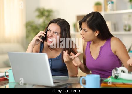 Zwei wütende Studenten behaupten, zu Hause telefonieren zu können Stockfoto