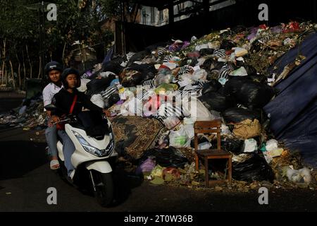 9. Oktober 2023, Yogyakarta, Spezialregion Yogyakarta, Indonesien: Motorradfahrer fahren in der Nähe von Müllhaufen in Yogyakarta vorbei. (Kreditbild: © Angga Budhiyanto/ZUMA Press Wire) NUR REDAKTIONELLE VERWENDUNG! Nicht für kommerzielle ZWECKE! Stockfoto