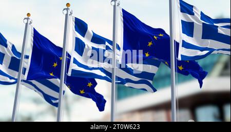 Nationalflaggen Griechenlands, die im Wind winken, mit Flaggen der Europäischen Union. 3D-Darstellung. Selektiver Fokus. Gewelltes Material Stockfoto
