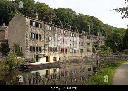 Traditionelle Reihenhütten und Boot neben dem Rochdale Canal an der Hebden Bridge West Yorkshire England Stockfoto