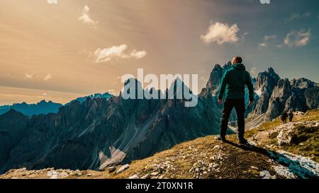 Inmitten der Pracht der Berge steht ein einsamer Mann als Zeugnis menschlichen Geistes und Abenteuers. Stockfoto