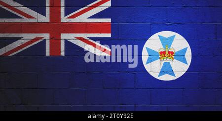 Die Flagge von Queensland ist auf einer Wand aus einem Schlackenblock gemalt. Stockfoto