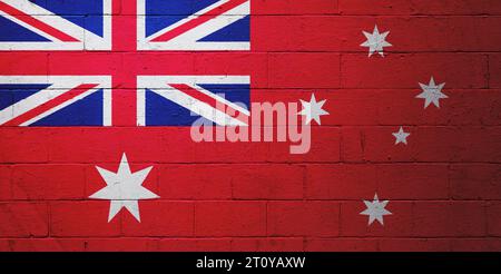 Australische rote Fahne, gemalt auf einer Wand aus einem Schlackenblock. Stockfoto