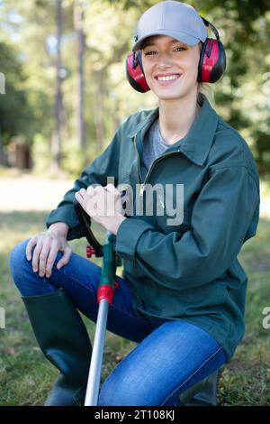 Junge Frau mäht das Gras Stockfoto