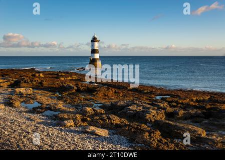 Penmon Point an der Küste von Anglesey, Nordwales. Der berühmte Leuchtturm von Trwyn du bei Morgensonne. Stockfoto