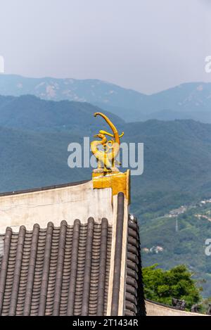 Nahansicht der Kranistatue auf dem Dach eines Tempels mit Panoramablick auf die Bergkette. Stockfoto