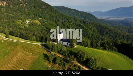 Slowenien, St.. Primoz-Kirche, Jamnik, majestätische Sonnenaufgangslandschaft von oben, berühmte Kirche auf grünem Hügel in Kranj, Gorenjska Stockfoto