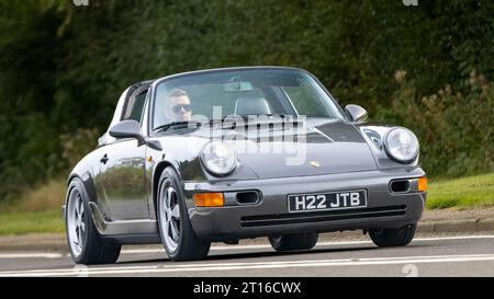 Bicester,Oxon.,UK - 8. Oktober 2023: 1990 graue Porsche 911 Carrera 2 Cabriolet Oldtimer auf einer englischen Landstraße. Stockfoto