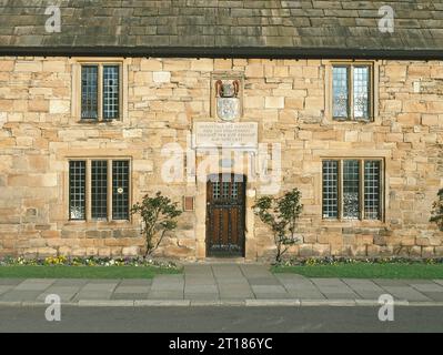 Die historische Fassade aus Mauerwerk und der Eingang zu einem der Almshouses von Bischof Cosin auf Palace Green, das 1666 in Durham gegründet wurde, zeigen Zeichen für eine moderne Umgestaltung als Café - Restaurant in dieser 1999-Ansicht, alle befinden sich innerhalb der Durham Cathedrals, die zum UNESCO-Weltkulturerbe gehören, England Großbritannien Stockfoto