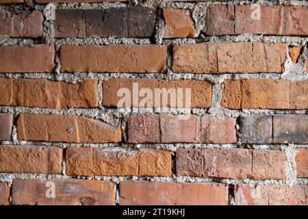 Eine Textur aus einem alten grunge roten Backsteinmauerhintergrund Stockfoto