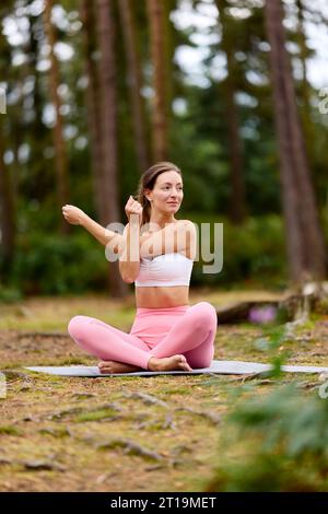 Wunderschönes Mädchen, das im Freien Yoga praktiziert Stockfoto