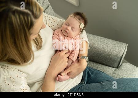 Nahaufnahme des Überkopfbildes einer Mutter, die das Neugeborene hält; Greiffinger Stockfoto