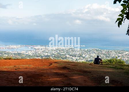 Einsame männliche Figur, die vom Berg Aorai in tahiti nach Papeete blickt Stockfoto