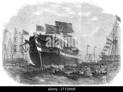 Start des Kampfschiffs "Anson" in Woolwich, 1860. Das Schiff der Royal Navy startete '...in mit mindestens 5000 Zuschauern. Die Band der Woolwich-Division der Royal Marine Light Infantry war in einem Orchester in der Nähe des Hecks des Schiffes stationiert und nicht zuletzt beeindruckender Teil der Szene war das Flaggenschiff der Fisgard, die Hebe, Salsette, und andere Schiffe im Hafen mit überfüllten Decks, und von vorne bis hinten mit Bündeln bedeckt... die Bewaffnung, die vom Royal Arsenal geliefert werden soll, wird aus 91 Kanonen bestehen... Ihre Maschinen [800 PS-Motoren] sind mA Stockfoto